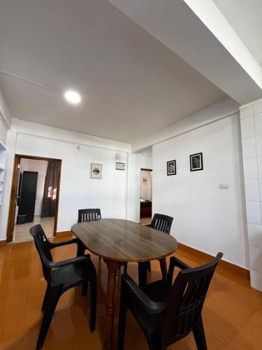 a dining room with a wooden table and chairs at Bandasa homestay in Shillong