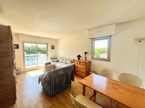 un salon avec un canapé et une table dans l'établissement Appartement T2 idéalement situé à Arcachon - Proche plage, commerces et gare - Parking privé - FR-1-319-452, à Arcachon