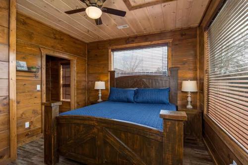 a bedroom with a wooden bed in a cabin at Center of It All Walk to Old Mill 3minDollywood in Pigeon Forge