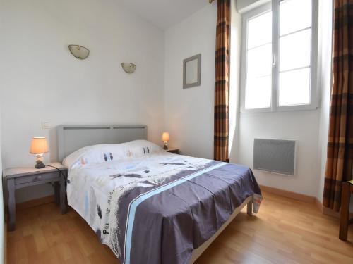 a white bedroom with a bed and a window at Modern holiday home in Crux-La-Ville with terrace in Crux-la-Ville