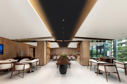 a dining room with tables and chairs and windows at Atour Hotel Xiamen Guanyinshan East Huandao in Xiamen