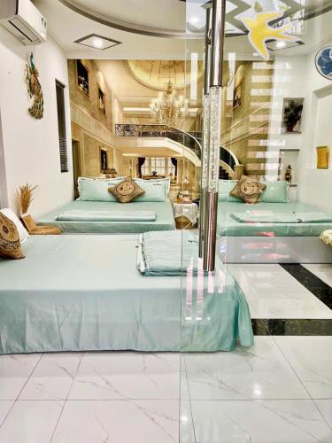 a room with a bunch of beds in it at Hoàng Nga Apartment Phan Thiết in Phan Thiet