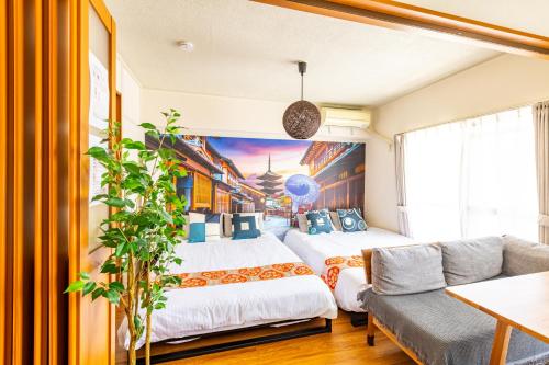 a bedroom with two beds and a couch at SakuraFlat in Tokyo