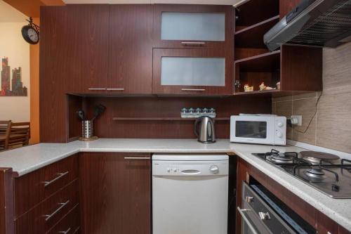 a kitchen with wooden cabinets and a stove top oven at 7new building near Republic Square in Yerevan