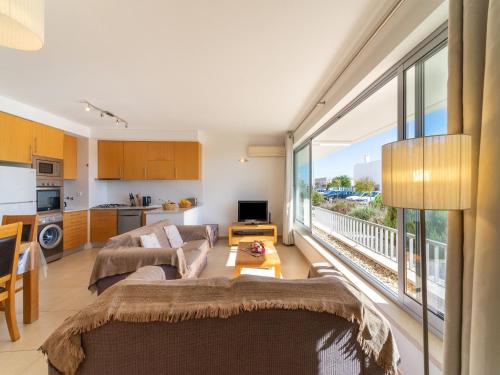 een woonkamer met 2 banken en een groot raam bij An Idyllic Algarve Home by the Water, cleaning included in Fuzeta