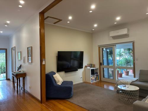 a living room with a flat screen tv on the wall at Jack's House 2 B&B in Mill Street in Clare
