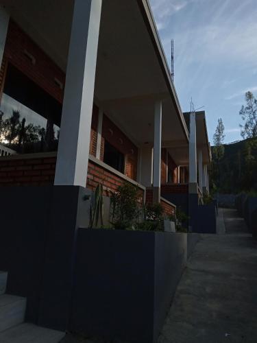 a house with a porch and stairs in front of it at Ikiikahomestay in Probolinggo