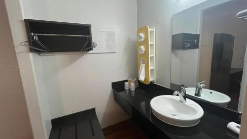 a bathroom with a sink and a mirror at Motel 6 Modesto, CA in Modesto