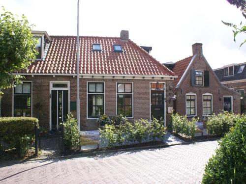 a brick house with a red roof at Fantastic luxury vacation home and next to the Wadden Sea in Paesens