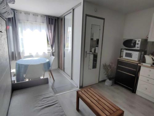 - un petit salon avec une table et un four micro-ondes dans l'établissement Studio cabine 4 pers., proche plage, quartier Falaises - FR-1-607-225, au Cap d'Agde