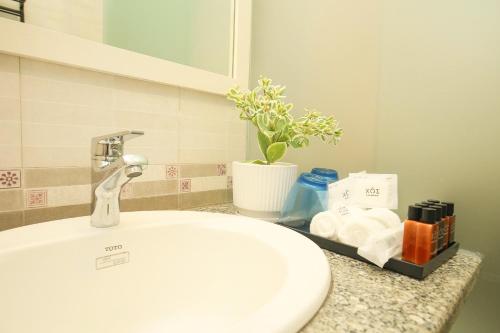 a bathroom counter with a sink and a white sink at The Mira Villa West Lake by XÔI Residences in Hanoi