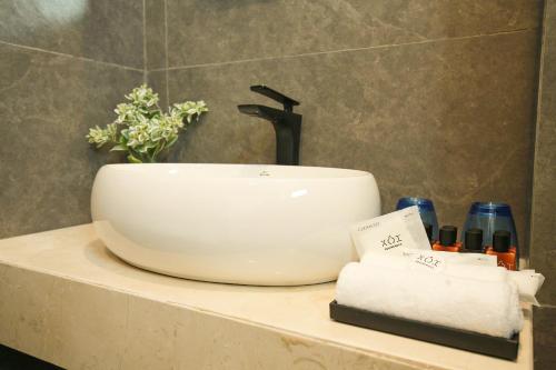 a bathroom sink sitting on a counter in a bathroom at The Mira Villa West Lake by XÔI Residences in Hanoi