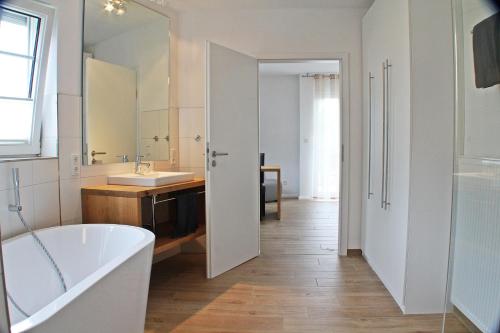 a bathroom with a tub and a sink at Weingut Gehlen-Cornelius in Brauneberg