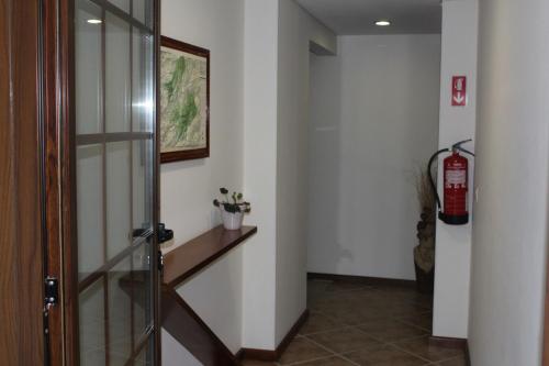 a hallway with a fire hydrant and a fire extinguisheracistacistacistacist at Pála dos Mouros in Geres