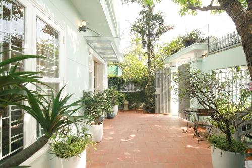 a courtyard with potted plants on a house at The Mira Villa West Lake by XÔI Residences in Hanoi