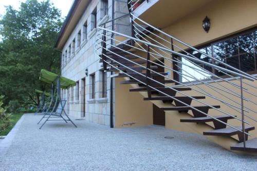 a metal staircase on the side of a building at Pála dos Mouros in Geres