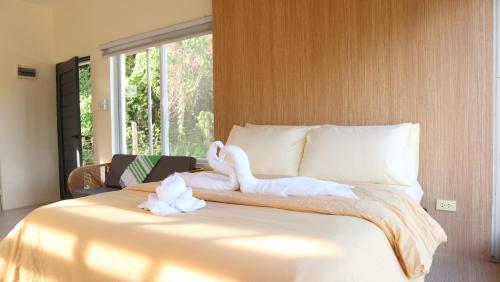 a bedroom with a bed with a swan on it at Port Kalaya in El Nido