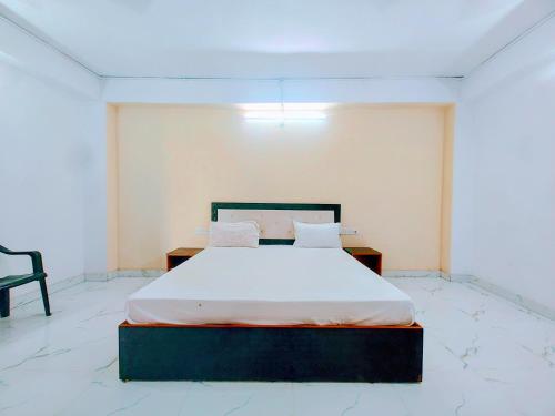 a bedroom with a bed and a chair at Hotel Trilok a comfort Room in Lucknow