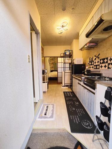 a kitchen with a stove and a counter top at 202 Airport and Disneyland direct bus Near Koiwa st in Tokyo