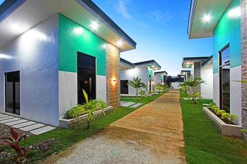 a row of houses with green and white at the Landing Villas rental in Panglao