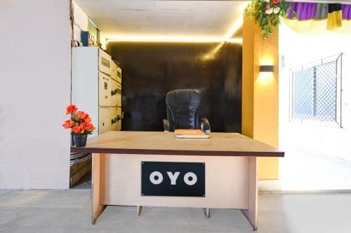 a desk with an ovo sign on it in a room at Hotel O Jannat in Chupra