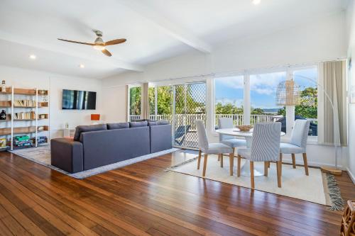 a living room with a couch and a table and chairs at Yaringa -13 Seaview Street SWR in South West Rocks