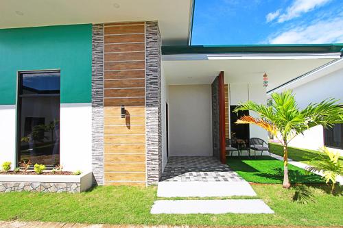 a house with a pathway leading to the front door at the Landing Villas rental in Panglao