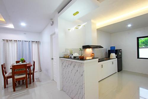 a kitchen with a counter and a table in a room at the Landing Villas rental in Panglao