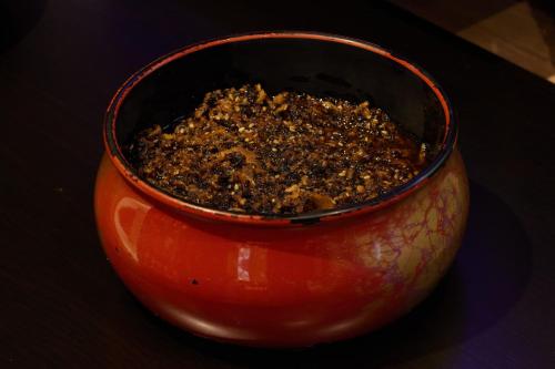 a red vase filled with dirt sitting on a table at Almont Hotel Sendai in Sendai