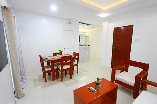 a dining room and living room with a table and chairs at the Landing Villas rental in Panglao