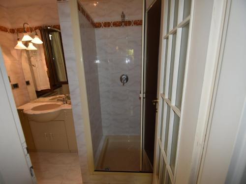 a shower with a glass door in a bathroom at Villa in Ghiffa with Lake Maggiore Views in Ghiffa