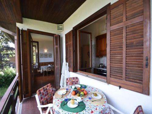 a table on the porch of a house at Villa in Ghiffa with Lake Maggiore Views in Ghiffa