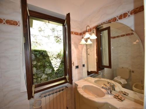 a bathroom with a sink and a large window at Villa in Valdora with Lake Maggiore Views in Ghiffa
