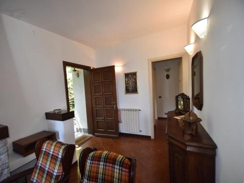 a living room with two chairs and a table at Villa in Valdora with Lake Maggiore Views in Ghiffa
