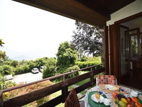 a table with a plate of fruit on a balcony at Villa in Valdora with Lake Maggiore Views in Ghiffa