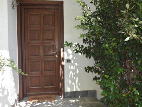 an open door to a house with a bush at Villa in Valdora with Lake Maggiore Views in Ghiffa