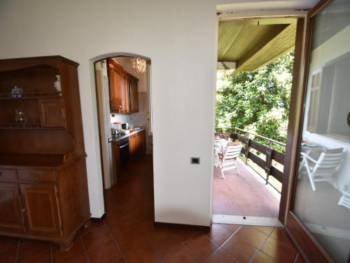 a kitchen with a door open to a balcony at Villa in Valdora with Lake Maggiore Views in Ghiffa