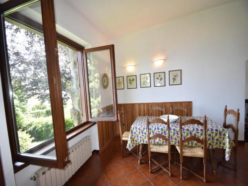a dining room with a table and two chairs at Villa in Valdora with Lake Maggiore Views in Ghiffa