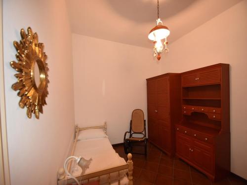 a bedroom with a bed and a dresser and a mirror at Villa in Valdora with Lake Maggiore Views in Ghiffa