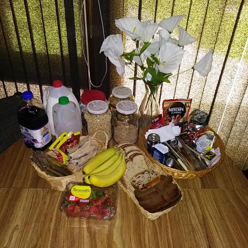 a table with a basket of food and a vase with flowers at HOUSE OF THE FUTURE MANSION MASTER BEDROOM, In W LANSING in Lansing