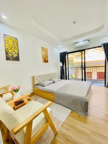 a bedroom with a bed and a table and a couch at Happy Nest Home - Long Bien in Hanoi