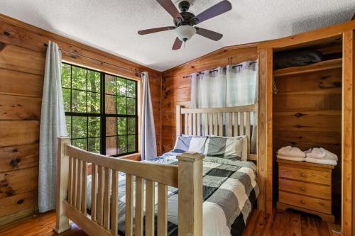 a bedroom with a bed and a ceiling fan at MTN Views, Hot Tub, WiFi, Sleeps 3 in Sevierville