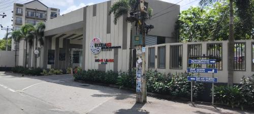 a pole with street signs in front of a building at Elixia Emerald 2 Bed Room Fully Furnished Apartment, Colombo, Malabe in Malabe