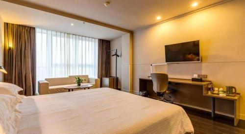 Ένα ή περισσότερα κρεβάτια σε δωμάτιο στο Jinjiang Inn Select Xixian New Distict Century Avenue