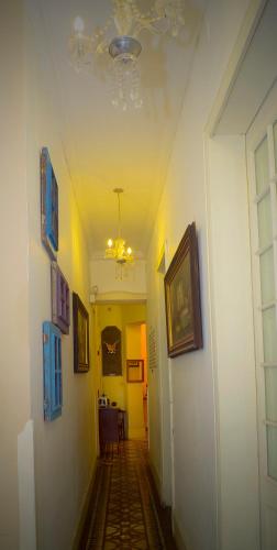 a hallway with a ceiling with a chandelier and pictures at Casa Falleri Boutique Hotel in Lima