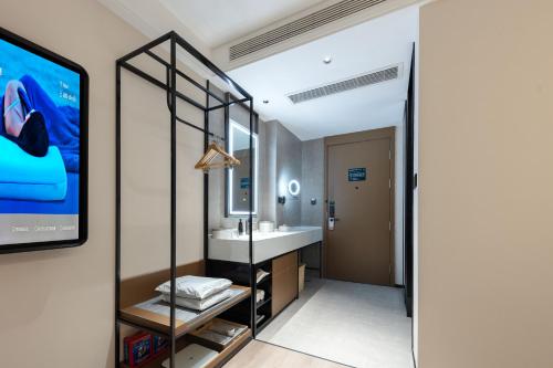 a bathroom with a sink and a mirror at Atour Hotel Xiamen Guanyinshan East Huandao in Xiamen