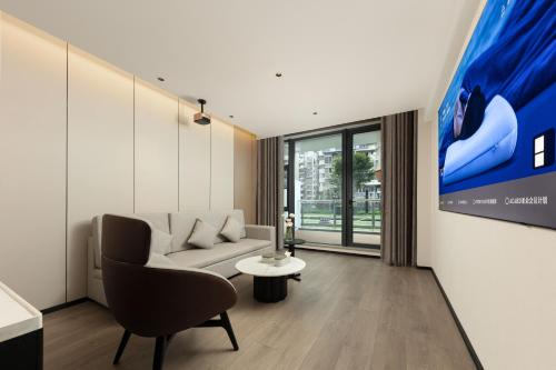 a living room with a couch and a tv at Atour Hotel Xiamen Guanyinshan East Huandao in Xiamen