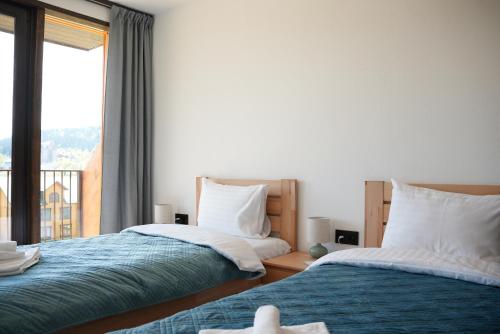Ένα ή περισσότερα κρεβάτια σε δωμάτιο στο Nafta Aparts & Villas