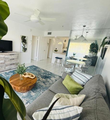 a living room with a couch and a table at Designer's 1 BR 1BA Condo 1 Block to Aventura Mall in Aventura