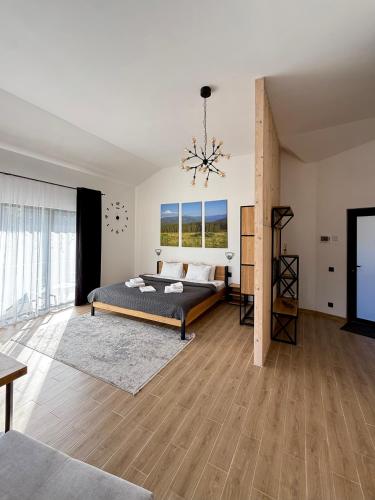 a bedroom with a bed and a chandelier at Шишка in Bukovel
